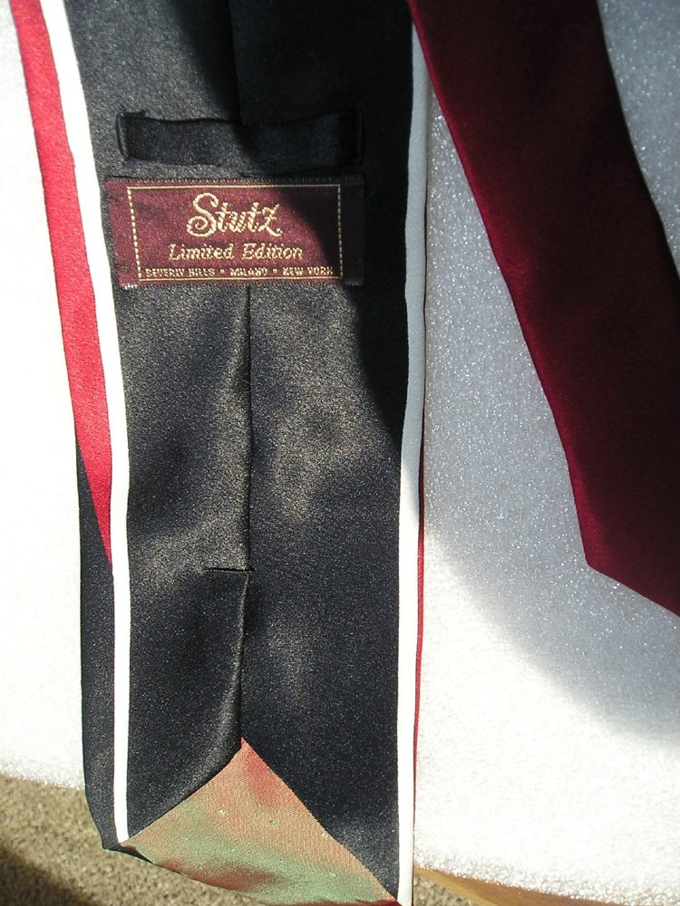 Stutz limited edition silk neckties in black satin with red and cream banding, and solid burgundy, with the woven Stutz label
